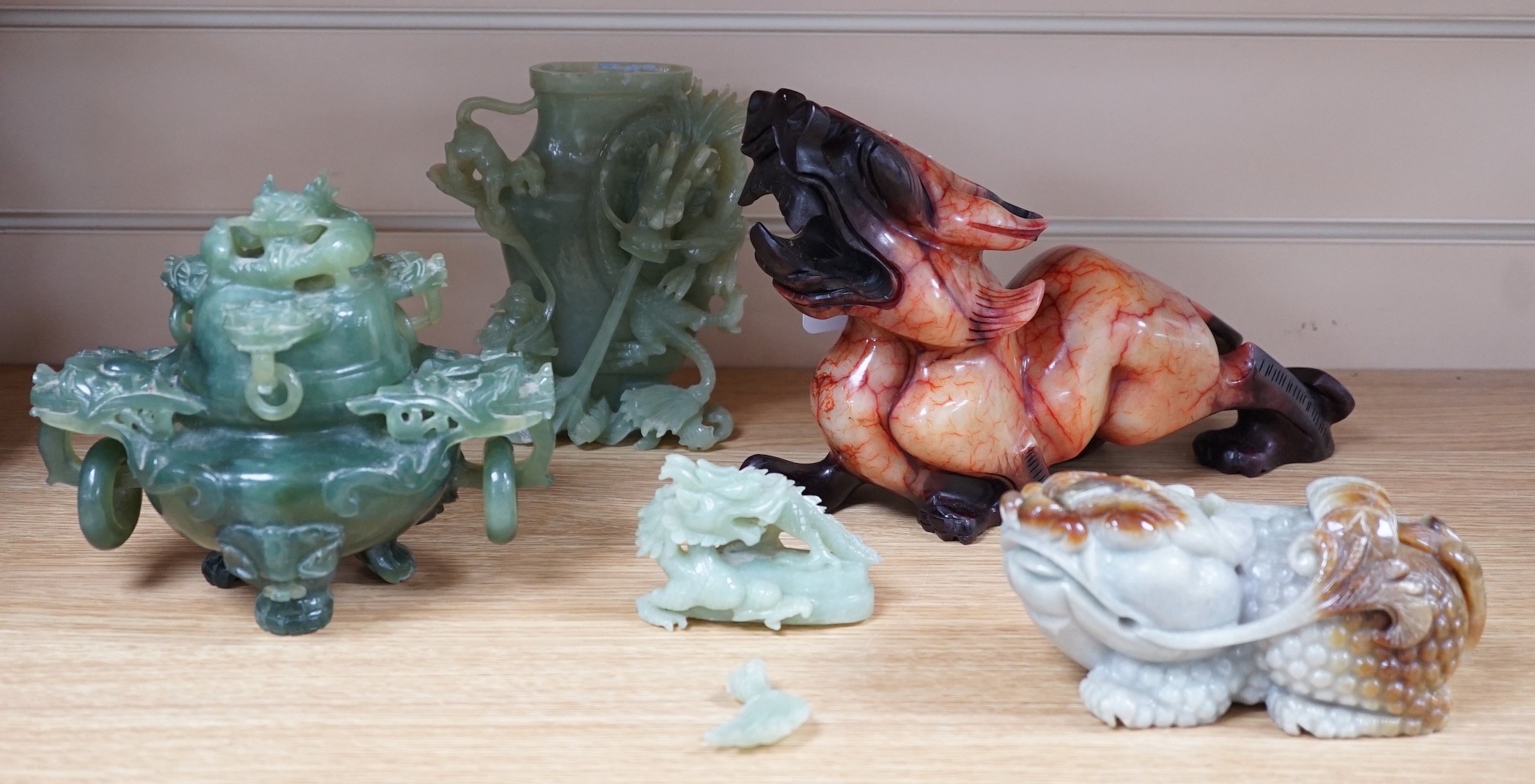 Four Chinese bowenite jade carvings - two mythical beasts, a censer and cover and a ‘dragon’ vase and cover, largest 28cm long